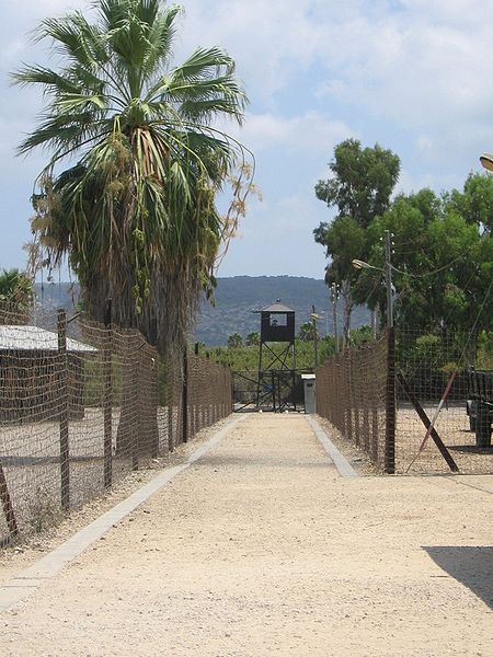 Fenced entrance corridor and watchtower at the restored Atlit camp