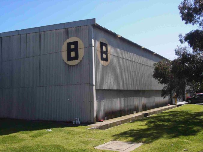 Former hostel building at the Brooklyn site, photographed for the municipal heritage study. The image records later industrial use, not conditions during migrant occupation.