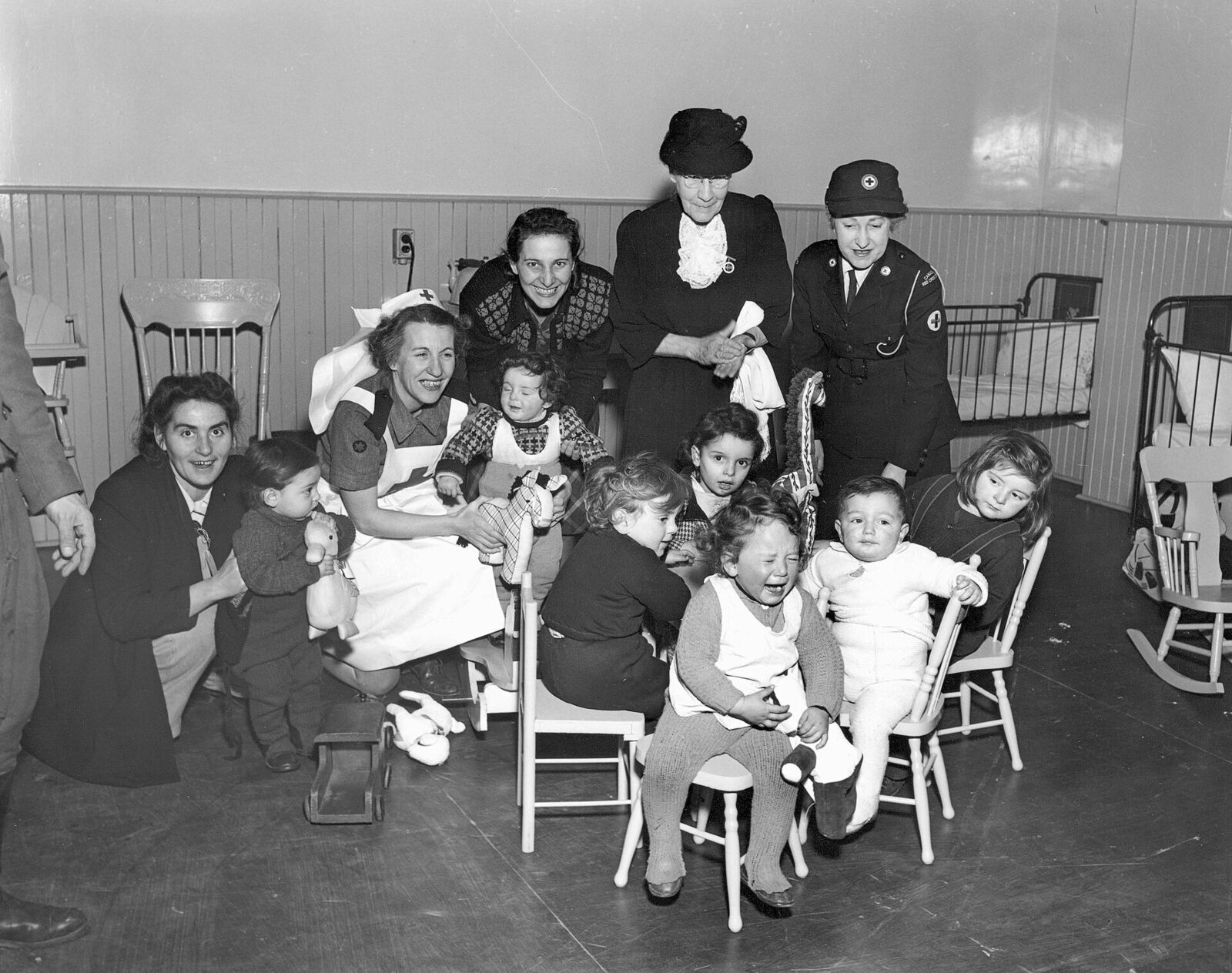 Immigrant children with Red Cross port workers at Pier 21, Halifax, in 1948.
