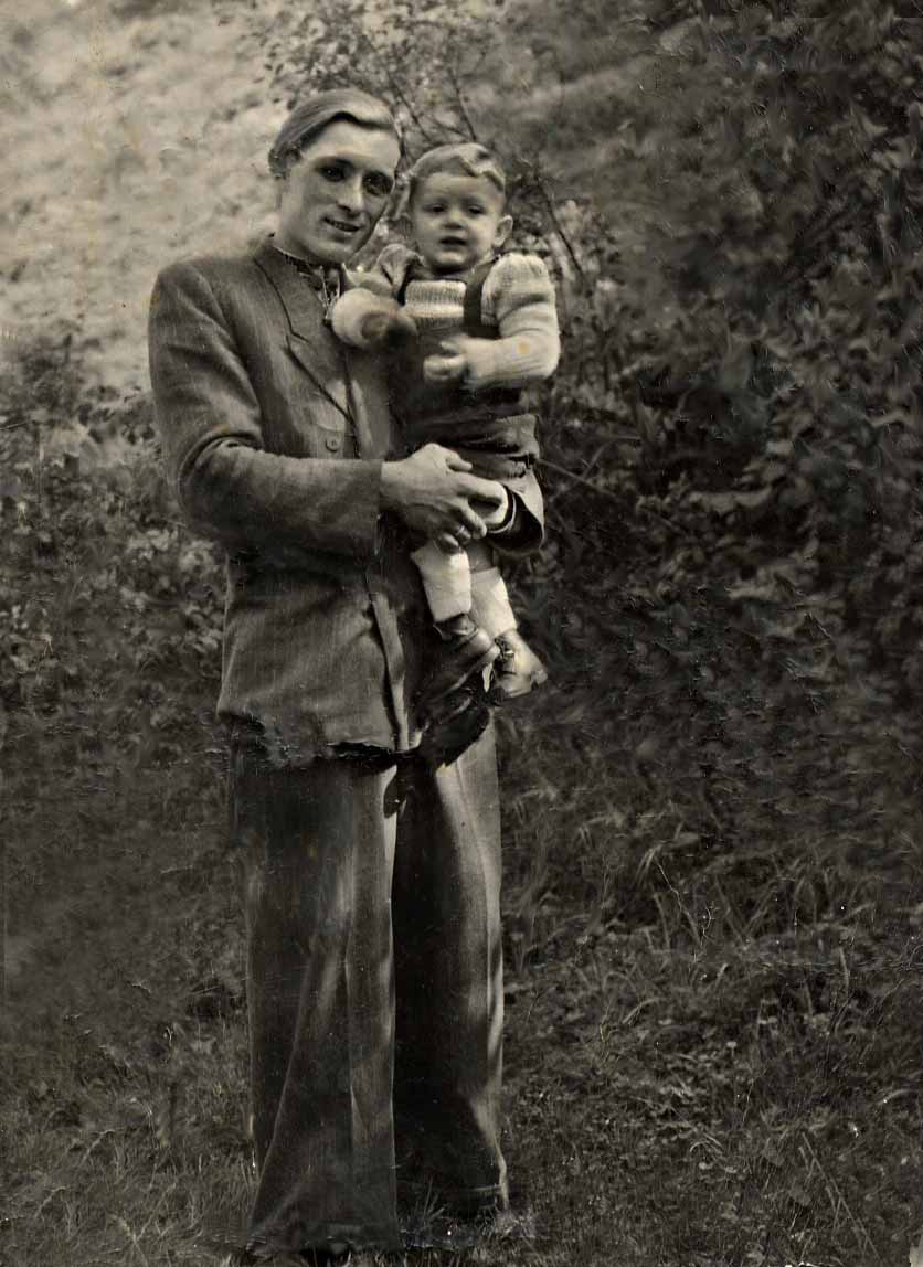Michael Hrynenko holding his two-year-old son Roman at Cornberg in 1949.