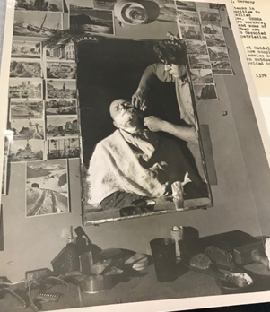 A barber’s mirror surrounded by photographs at a Hersfeld DP camp.