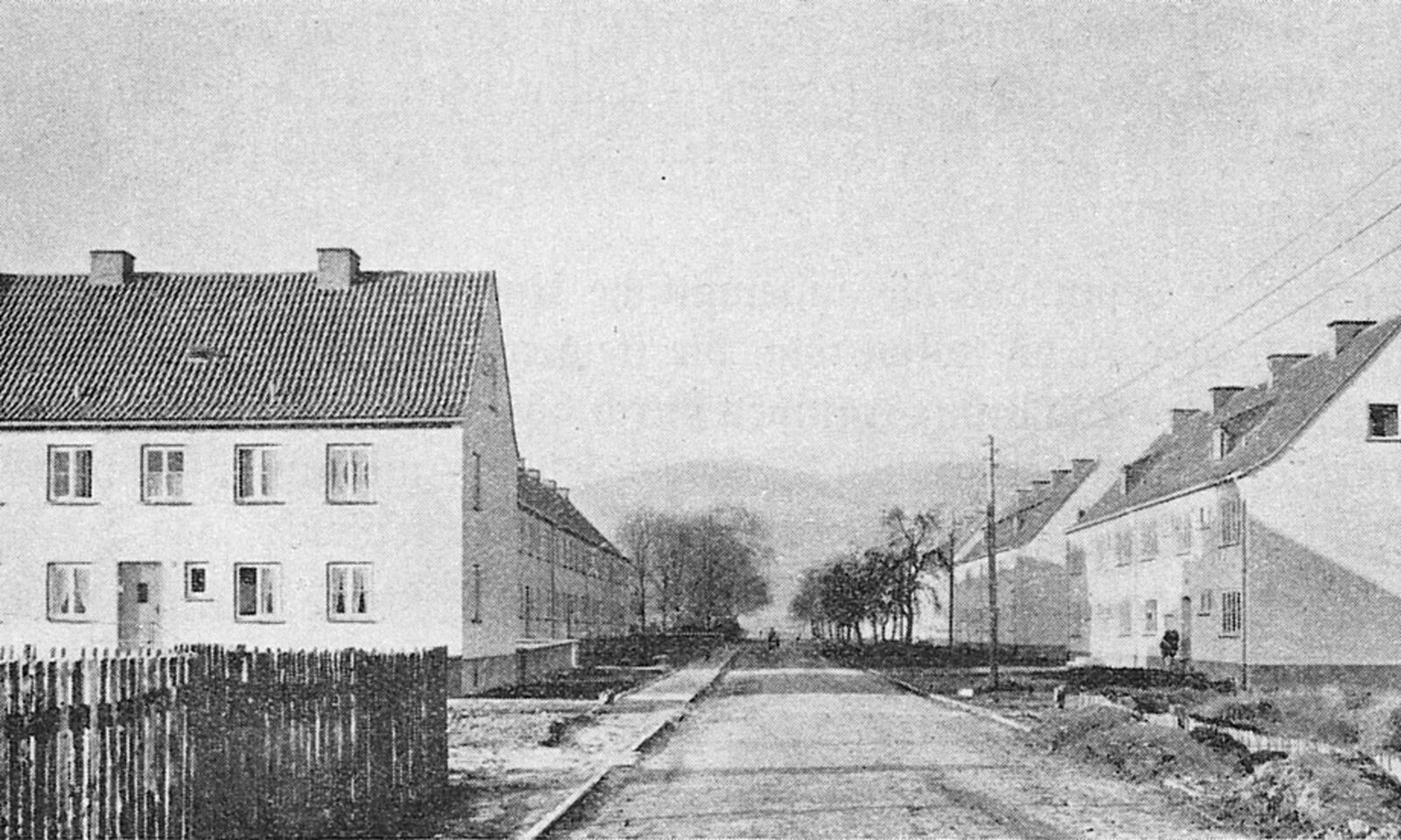 Two-storey workers’ houses beside an unfinished street