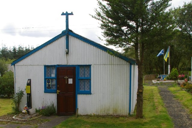 The chapel hut at Hallmuir, corrugated sheeting painted white with blue dressings and a three-barred cross on the gable.