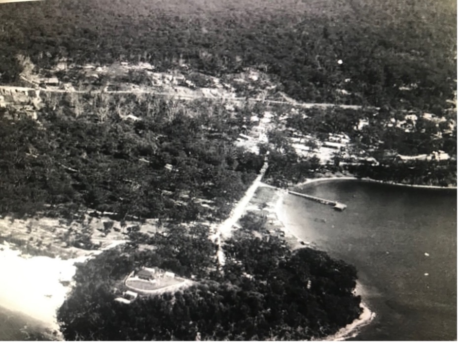 Nelson Bay migrant hostel in 1950, with Nissen huts extending towards Little Beach.