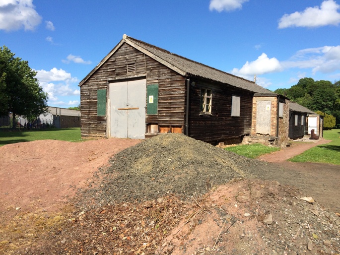 The gable and entrance of the timber hut before restoration.