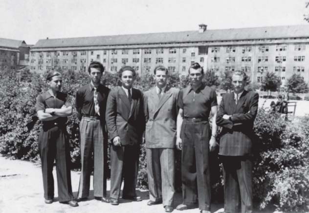 Residents photographed before the barracks in 1949.
