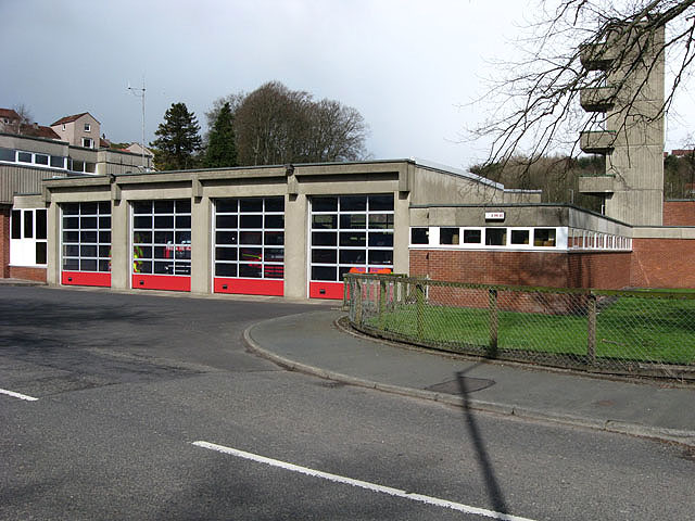 Hawick Fire Station with red appliance-bay doors and a concrete tower.