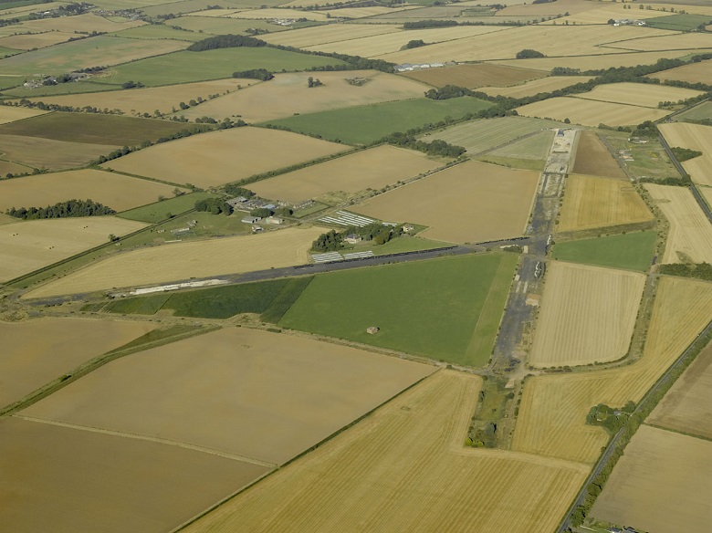 Two surviving airfield runways cross within farmland, seen from the air.